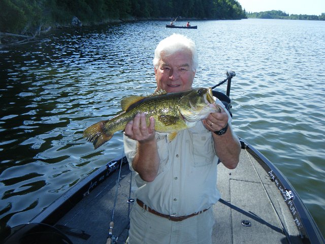 2012 fishing 017.jpg - Rae with a Largemouth Bass from the Golden Triangle Area.